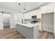 Modern kitchen with white cabinets, gray island, stainless appliances, and wood-look floors at 230 Sutherland Dr, Franklinton, NC 27525