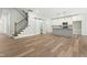 Open-concept living space with a staircase, a modern kitchen, and wood-look flooring at 230 Sutherland Dr, Franklinton, NC 27525