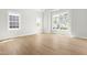 Sunlit bedroom with hardwood floors and three windows that provide natural light at 240 Sutherland Dr, Franklinton, NC 27525