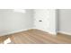 Bright bedroom featuring wood-look flooring and a built-in closet with black hardware at 240 Sutherland Dr, Franklinton, NC 27525