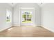 Bright bedroom boasts large windows and light wood flooring, creating a peaceful atmosphere at 240 Sutherland Dr, Franklinton, NC 27525