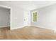 Inviting bedroom with light wood floors, a window with natural light, and neutral decor at 240 Sutherland Dr, Franklinton, NC 27525
