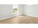 Empty bedroom featuring natural light and light colored hardwood flooring at 240 Sutherland Dr, Franklinton, NC 27525