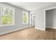 Light-filled bedroom with two large windows and wood-look floors at 240 Sutherland Dr, Franklinton, NC 27525