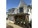 Two-story home with brick and white facade, manicured shrubs, and trimmed grass at 240 Sutherland Dr, Franklinton, NC 27525