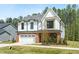 Two-story home with white facade, black trim, two-car garage, and green lawn at 240 Sutherland Dr, Franklinton, NC 27525