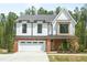 Charming two-story home with a brick and white facade, and a two-car garage at 240 Sutherland Dr, Franklinton, NC 27525