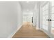 Bright hallway with light wood floors, white walls, and glass paneled doors, offering a clean, modern aesthetic at 240 Sutherland Dr, Franklinton, NC 27525