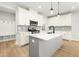 Modern kitchen featuring white cabinets, quartz countertops, and stainless steel appliances, perfect for culinary enthusiasts at 240 Sutherland Dr, Franklinton, NC 27525