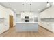 Modern kitchen with white cabinets, an island with pendant lighting, and stainless steel appliances, ready for entertaining at 240 Sutherland Dr, Franklinton, NC 27525