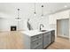 Kitchen island with a sink and faucet, accompanied by an open living area and staircase at 240 Sutherland Dr, Franklinton, NC 27525