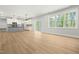 Bright living room with abundant natural light, open floor plan, and kitchen access at 240 Sutherland Dr, Franklinton, NC 27525