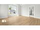 Bright main bedroom with plank floors, a large window, and an en-suite bathroom at 240 Sutherland Dr, Franklinton, NC 27525