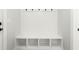 A white mud room with storage and six coat hooks at 240 Sutherland Dr, Franklinton, NC 27525