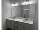 Bathroom with double sink vanity and a large mirror complemented by modern lighting fixtures at 269 Marvel Dr # 138, Rolesville, NC 27571