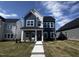 Charming two-story home featuring blue and white siding, a brick accent, and a well-manicured front yard at 269 Marvel Dr # 138, Rolesville, NC 27571