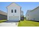 White home with a driveway and attached garage showcasing side yard with green grass at 269 Marvel Dr # 138, Rolesville, NC 27571