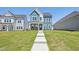 Attractive two-story home with a green lawn and inviting walkway to the covered front porch at 269 Marvel Dr # 138, Rolesville, NC 27571
