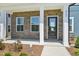 Inviting covered porch with brick accents and stylish front door at 269 Marvel Dr # 138, Rolesville, NC 27571