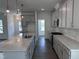 Well-appointed kitchen with a large island, gray cabinets, stainless steel appliances, and modern lighting at 269 Marvel Dr # 138, Rolesville, NC 27571
