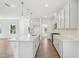 Open kitchen with a center island, white cabinets, and hardwood floors at 269 Marvel Dr # 138, Rolesville, NC 27571