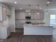 Spacious kitchen boasting gray cabinets, stainless steel appliances, a subway tile backsplash, and an island with a sink at 269 Marvel Dr # 138, Rolesville, NC 27571