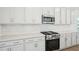 Modern kitchen showcasing white cabinets, stainless steel appliances, and quartz countertops at 269 Marvel Dr # 138, Rolesville, NC 27571