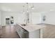 Open concept with quartz island, gray cabinets, and a stainless steel sink under pendant lights at 269 Marvel Dr # 138, Rolesville, NC 27571
