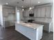 Open kitchen featuring a large island, gray cabinetry, pendant lighting, and stainless steel appliances at 269 Marvel Dr # 138, Rolesville, NC 27571