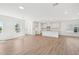 Spacious open-concept living area with hardwood floors and a view into the modern kitchen at 269 Marvel Dr # 138, Rolesville, NC 27571
