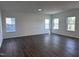 Bright, spacious living room featuring hardwood flooring, recessed lighting, and multiple windows for abundant natural light at 269 Marvel Dr # 138, Rolesville, NC 27571