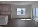 Open-concept living room adjacent to the kitchen, featuring wood-look flooring and sliding glass doors to the patio at 269 Marvel Dr # 138, Rolesville, NC 27571