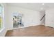 Spacious living room featuring wood floors, natural light, and access to stairs and a sliding glass door at 269 Marvel Dr # 138, Rolesville, NC 27571