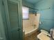 The bright bathroom features a tiled floor, a bathtub and toilet at 2711 Ashe St, Durham, NC 27703