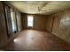 Wood paneled primary bedroom with windows, ceiling fan, and closet at 2711 Ashe St, Durham, NC 27703