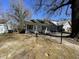 Cottage-style home's front yard and driveway with neighboring homes and mature landscaping at 2711 Ashe St, Durham, NC 27703