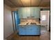 The classic kitchen features vintage blue cabinets and tiled flooring at 2711 Ashe St, Durham, NC 27703
