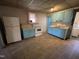 This kitchen features classic appliances, blue cabinetry, and durable tiled flooring at 2711 Ashe St, Durham, NC 27703