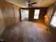 Cozy living room with ceiling fan, wood-paneled walls, and natural light from windows at 2711 Ashe St, Durham, NC 27703