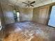 Empty living room featuring hardwood floors, paneled walls, ceiling fan, and natural light at 2711 Ashe St, Durham, NC 27703