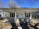 Close up of the home's covered porch with railing and front door at 2711 Ashe St, Durham, NC 27703