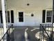 Covered front porch with stairs and railing leading to the front door at 2711 Ashe St, Durham, NC 27703