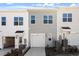 Exterior townhome view showing the garages, landscaping, and the architectural details at 280 Chesapeake Commons St # 151, Garner, NC 27529