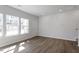 Inviting living room features wood flooring and large windows for ample natural light at 280 Chesapeake Commons St # 151, Garner, NC 27529