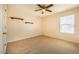 Bright bedroom with a ceiling fan, carpet flooring, window and two floating shelves at 314 Mason Trace, Burlington, NC 27217