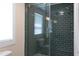 Modern walk-in shower featuring subway tile and glass door at 321 W Chatham St, Cary, NC 27511