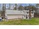 Aerial view of the home and backyard, revealing a patio, well-kept lawn, and mature trees at 3405 Wilsons Mills Rd, Smithfield, NC 27577