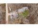 Distant aerial view of a home nestled among trees with surrounding vehicles and sheds at 3405 Wilsons Mills Rd, Smithfield, NC 27577