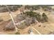 Aerial view of a property including a home, cleared land, and surrounding trees at 3405 Wilsons Mills Rd, Smithfield, NC 27577