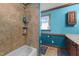 Bathroom features a shower-tub combo with tan tiling and built-in shelves at 3405 Wilsons Mills Rd, Smithfield, NC 27577